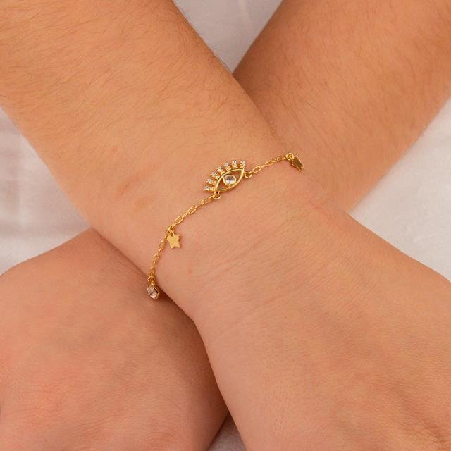 PULSEIRA FOLHEADO A OURO COM OLHO DE ZIRCÔNIAS E MINI GOTA E ESTRELA LISAS