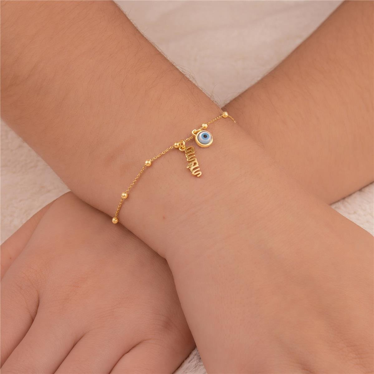 PULSEIRA FOLHEADO A OURO COM MINI BOLINHAS E OLHO GREGO COM AMÉM